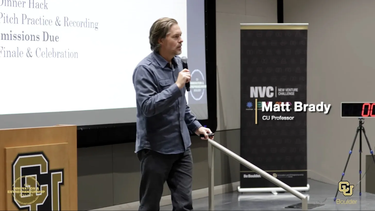 Matt Brady speaking on stage at the 2024 CU Boulder hackathon